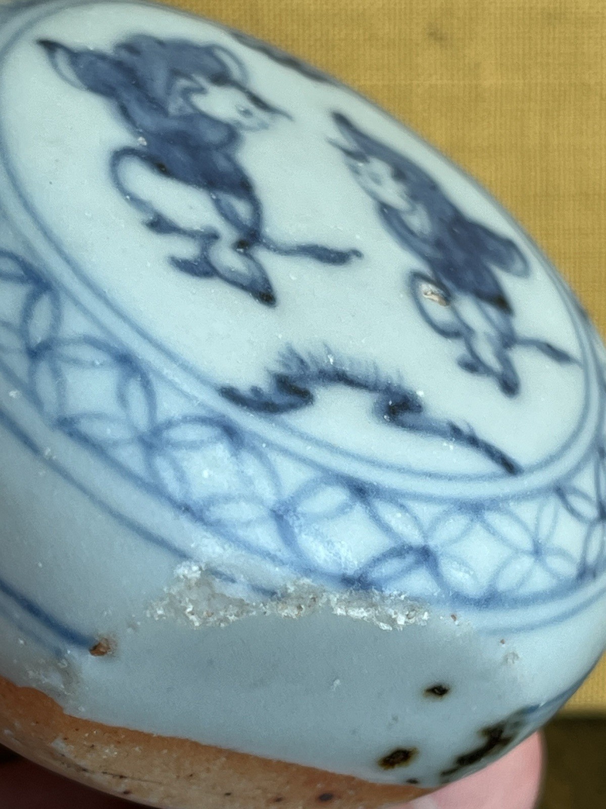 Antique blue and white porcelain paperweight with infant motif