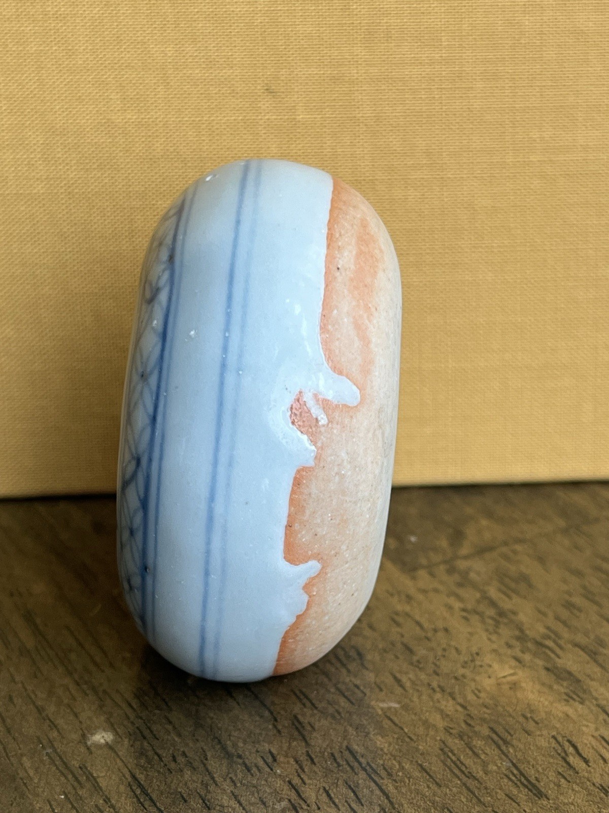 Antique blue and white porcelain paperweight with infant motif