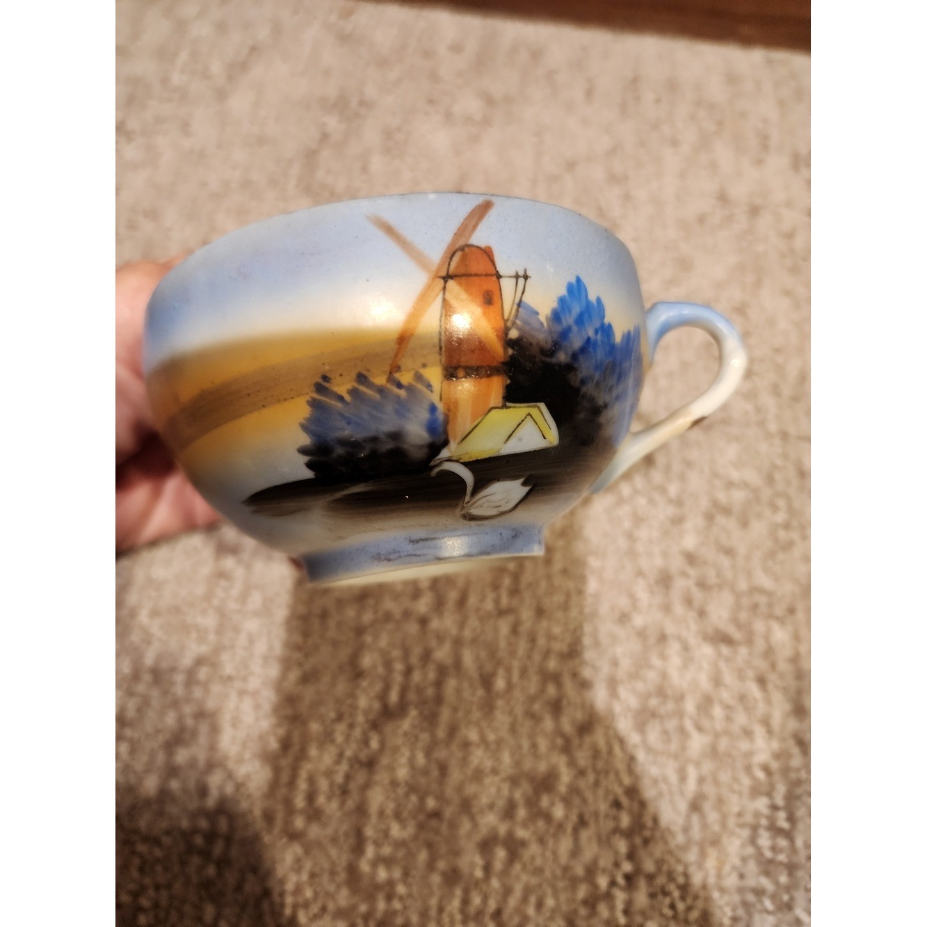 Hand-Painted Ceramic Teacup with Blue and Yellow Landscape Motif